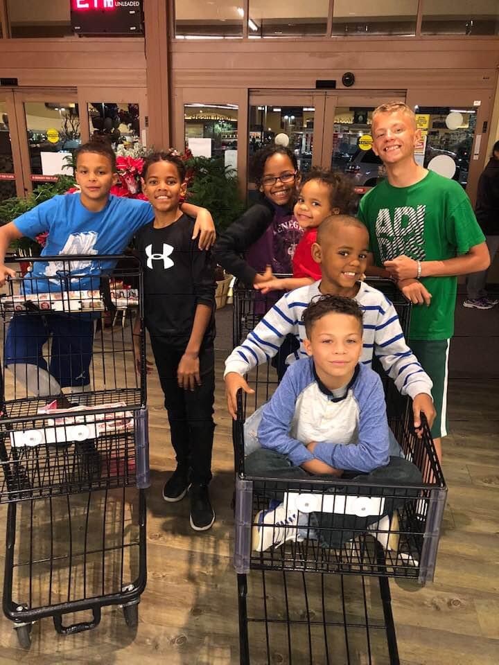 Children and community helpers gathering groceries for practical family support
