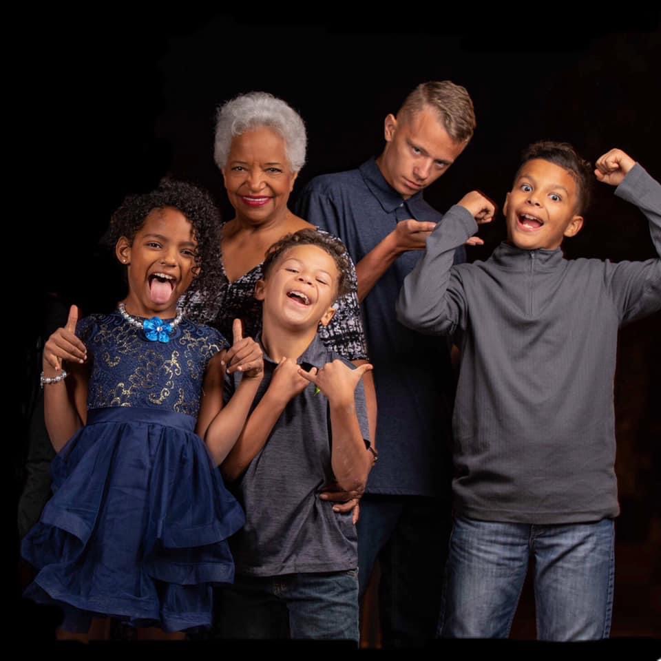 A grandmother sharing a joyful moment with four children